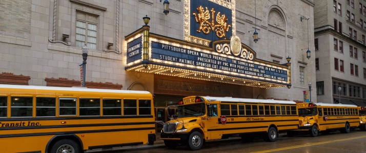 Yellow school buses line up under the Benedum Center marquee for a Pittsburgh Opera student matinee