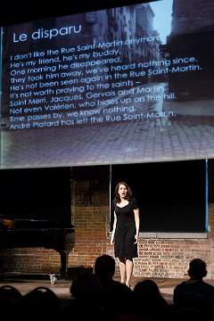 Claudia Rosenthal sings before projected lyrics to Le disparu at the November 2016 Art Song Recital