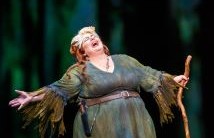 Marianne Cornetti as Jezibaba in a tattered green robe sings with arms spread in Pittsburgh Opera's Rusalka