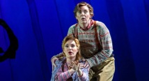 Gretel in a striped scarf and Hansel in a sweater cling together in the forest in Pittsburgh Opera's Hansel & Gretel