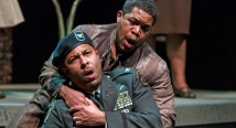 Older Thompson in a green beret holds the younger Thompson in Pittsburgh Opera's Glory Denied