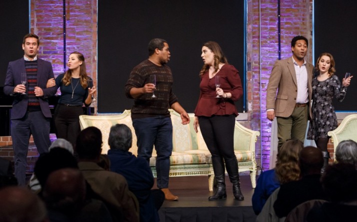 Six Resident Artists sing with glasses raised before a brick wall at an October 2018 Brown Bag concert