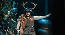 Ruggiero in antlers and gold armor gestures beside a gilded pile in Pittsburgh Opera's Alcina