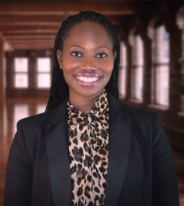 Jonnet Solomon in a black blazer and leopard-print blouse, portrait