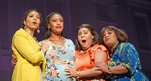 Four women in bright dresses comfort the grieving Mother in Pittsburgh Opera's Blue