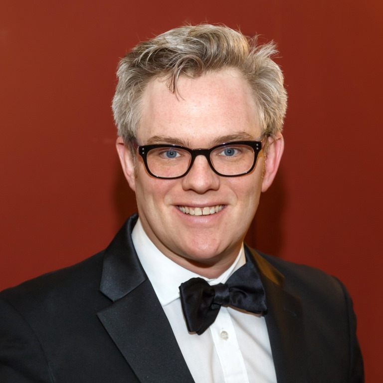 Robert Boldin in a tuxedo and glasses, portrait