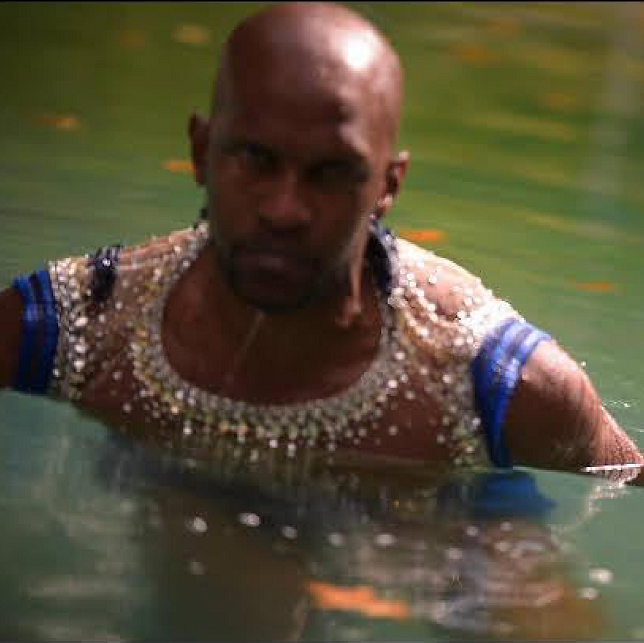 Ira Cambric III in a sequined costume waist-deep in water; OG in Pittsburgh Opera's We Shall Not Be Moved