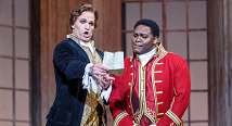 Count Almaviva in white and Figaro in a red military coat shake hands in Pittsburgh Opera's The Marriage of Figaro, 2022