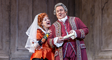 Susanna in a white veil laughs beside Figaro in a red brocade coat in Pittsburgh Opera's The Marriage of Figaro, 2022