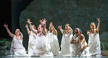 Women in white gowns raise their arms among stone ruins in Pittsburgh Opera's Iphigenie en Tauride