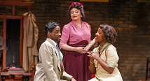 Mary Cardwell Dawson in pink joins the hands of two young singers in The Passion of Mary Cardwell Dawson