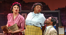 Three singers in 1940s dress, one in a yellow plaid skirt, in Pittsburgh Opera's The Passion of Mary Cardwell Dawson