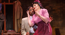 Mary Cardwell Dawson in pink sings with a man in a tan suit behind her in The Passion of Mary Cardwell Dawson