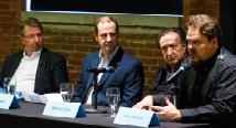 Four panelists seated at a table with microphones and name cards at an Opera Up Close