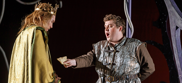 A crowned king in a green robe listens as a man in a fur-trimmed tunic offers a letter in Pittsburgh Opera's Ariodante, 2023