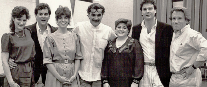 An old picture of three women and four men posing for a group picture