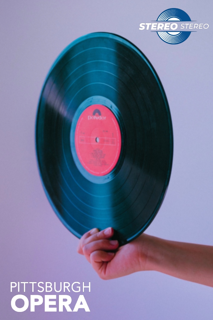A hand holds up a vinyl record with a red Polydor label; Stereo Stereo and Pittsburgh Opera