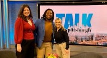 Three guests pose before the Talk Pittsburgh set