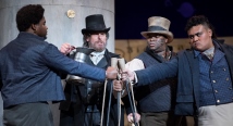 Captain Ahab on a peg leg with sailors in a scene from Utah Opera's Moby-Dick