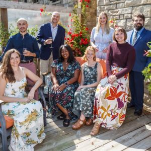Group portrait on a garden deck at the Friends of Pittsburgh Opera Resident Artists welcome party