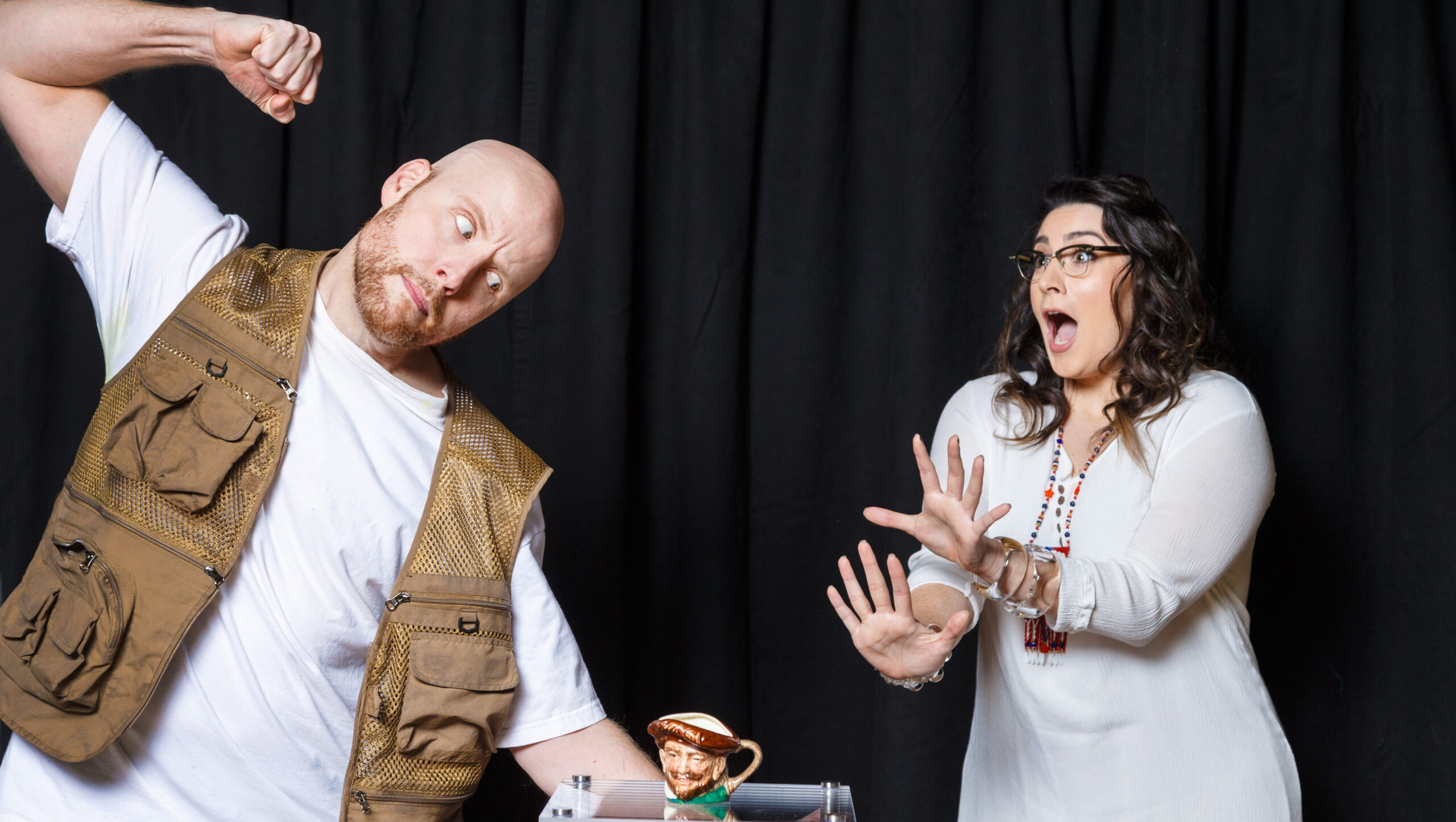 A bald man in a fishing vest raises a fist over a Toby jug as a woman in white gasps in The Last American Hammer