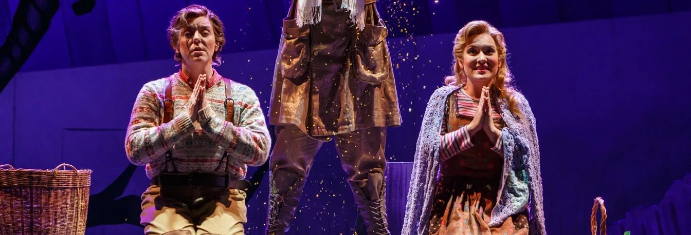 Hansel and Gretel kneel praying as the Sandman scatters glitter above them in Pittsburgh Opera's Hansel & Gretel