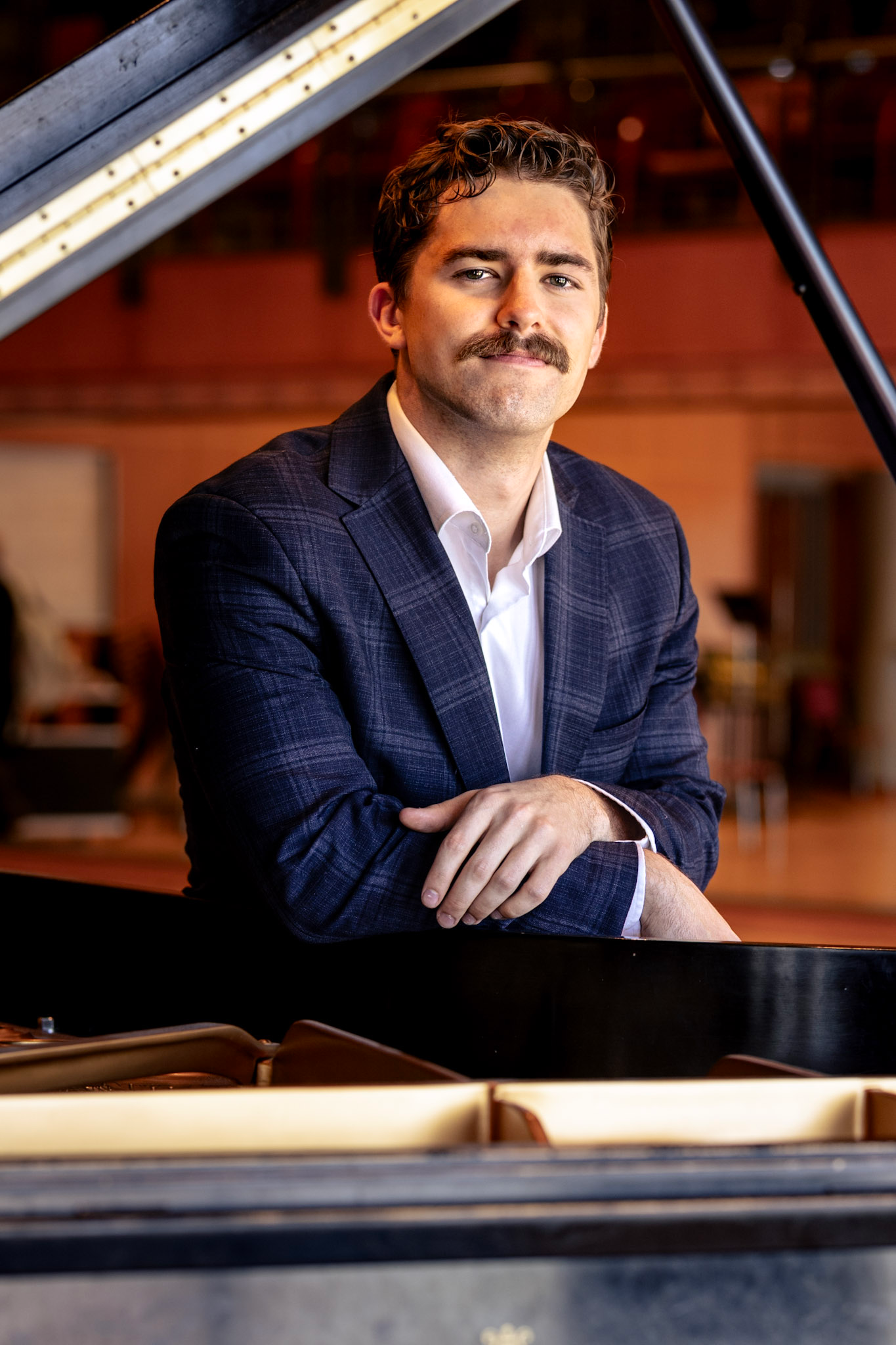 Joseph Stevens, portrait at a grand piano; Pittsburgh Opera Resident Artist 2026-27